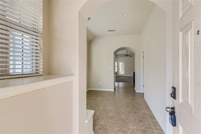 a view of a hallway with wooden floors and cabinet