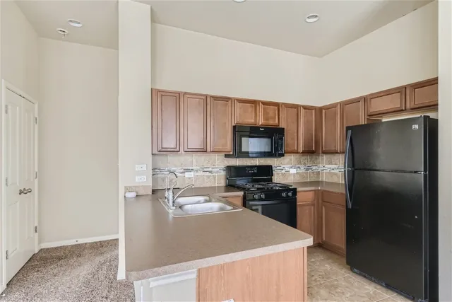 a kitchen with stainless steel appliances granite countertop a refrigerator stove a sink and dishwasher