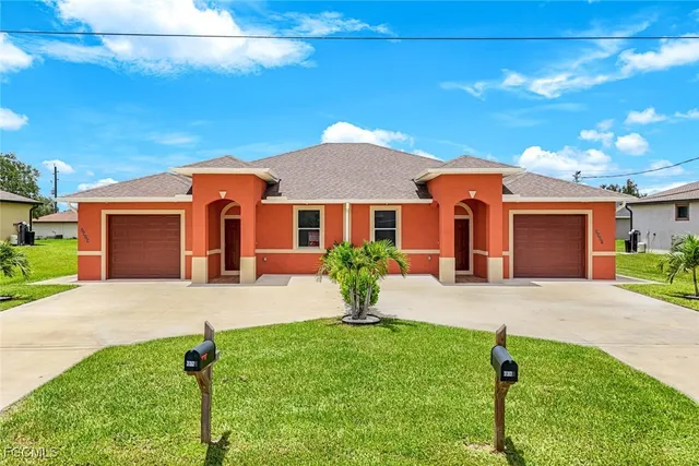a front view of a house with a yard and garage
