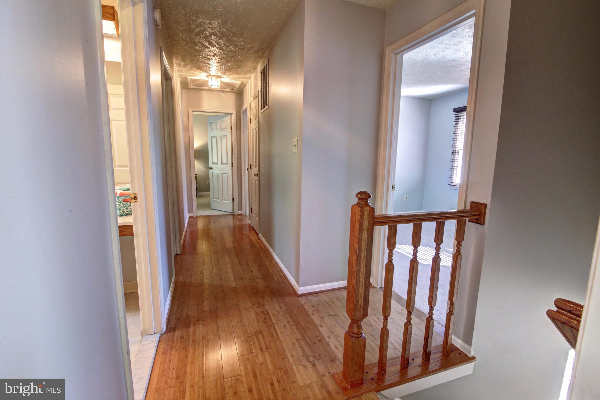12712 Roark Court Reston, VA 20191 - Photo 13 of 30 H/W Flrs leads to 5 large Bdrms all w/ NEW carpet