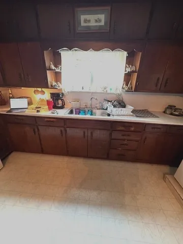 a kitchen with stainless steel appliances granite countertop a sink a stove and a microwave oven