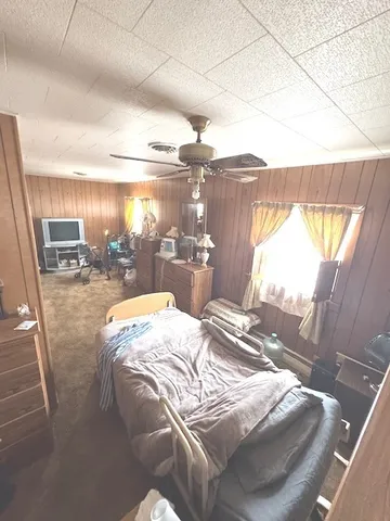 a bed sitting in a bedroom next to a window