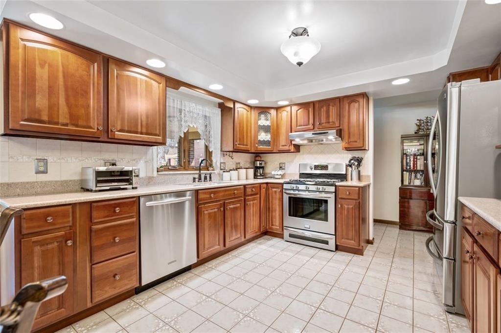236 Philander Street Pittsburgh, PA 15218 - Photo 11 of 35 a kitchen with stainless steel appliances granite countertop a stove sink and cabinets