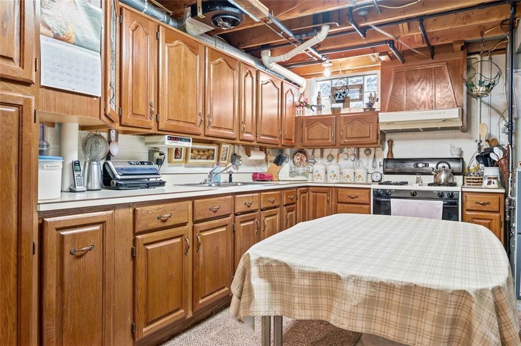 236 Philander Street Pittsburgh, PA 15218 - Photo 29 of 35 a kitchen with stainless steel appliances granite countertop a sink dishwasher and cabinets with wooden floor