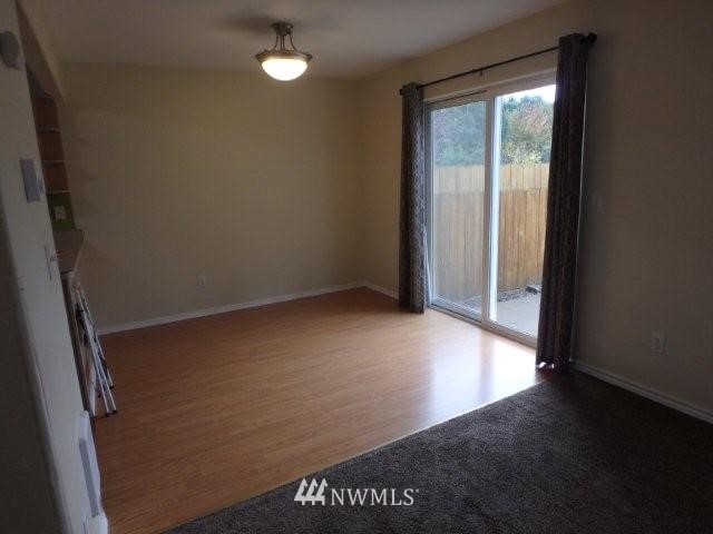 901 North Harding Road Elma, WA 98541 - Photo 11 of 22 an empty room with wooden floor and windows