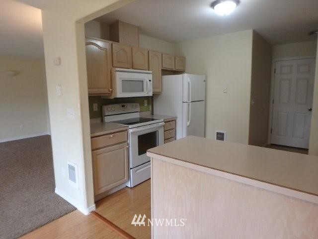 901 North Harding Road Elma, WA 98541 - Photo 17 of 22 a kitchen with a refrigerator sink and stove top oven