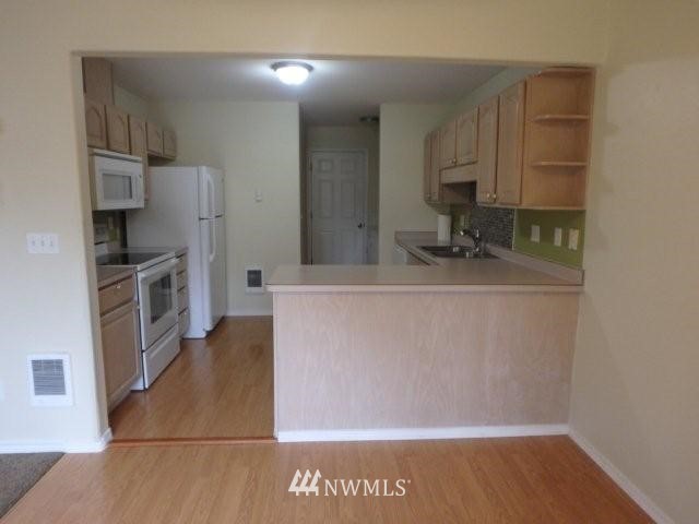 901 North Harding Road Elma, WA 98541 - Photo 18 of 22 a kitchen with stainless steel appliances granite countertop a refrigerator and a sink