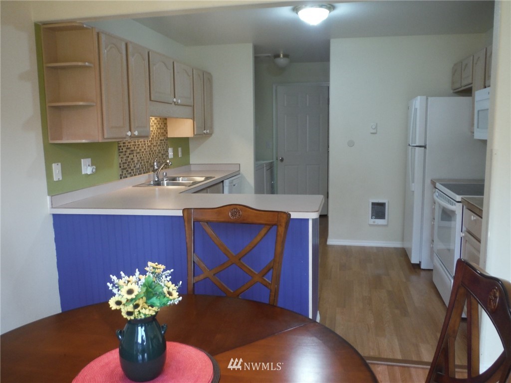 901 North Harding Road Elma, WA 98541 - Photo 5 of 22 a kitchen with stainless steel appliances granite countertop a sink cabinets and wooden floor