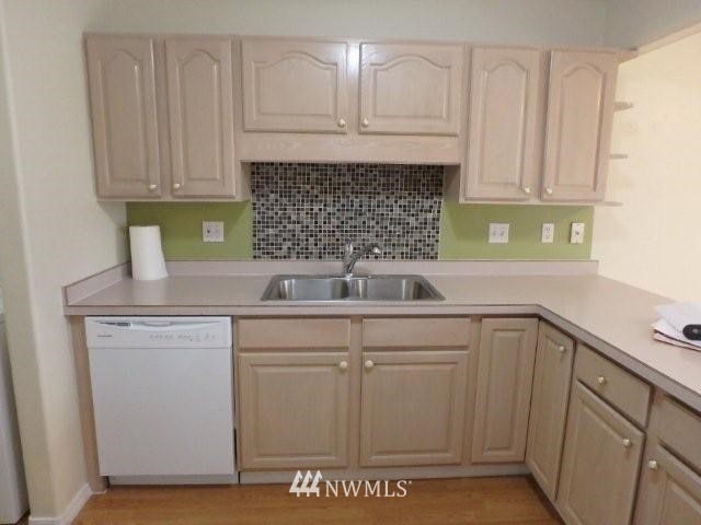 901 North Harding Road Elma, WA 98541 - Photo 8 of 22 a kitchen with a sink cabinets and wooden floor