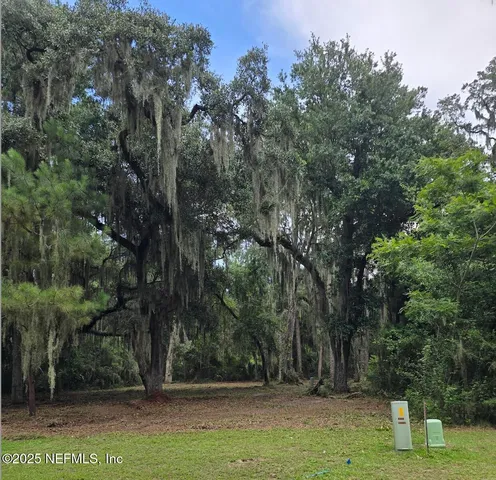 a view of outdoor space with deck area and trees