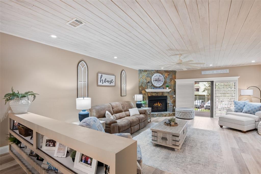 529 Sandy Hook Road Treasure Island, FL 33706 - Photo 15 of 55 a living room with furniture and a fireplace