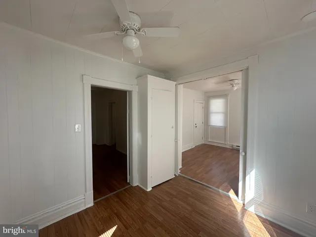 an empty room with closet and windows