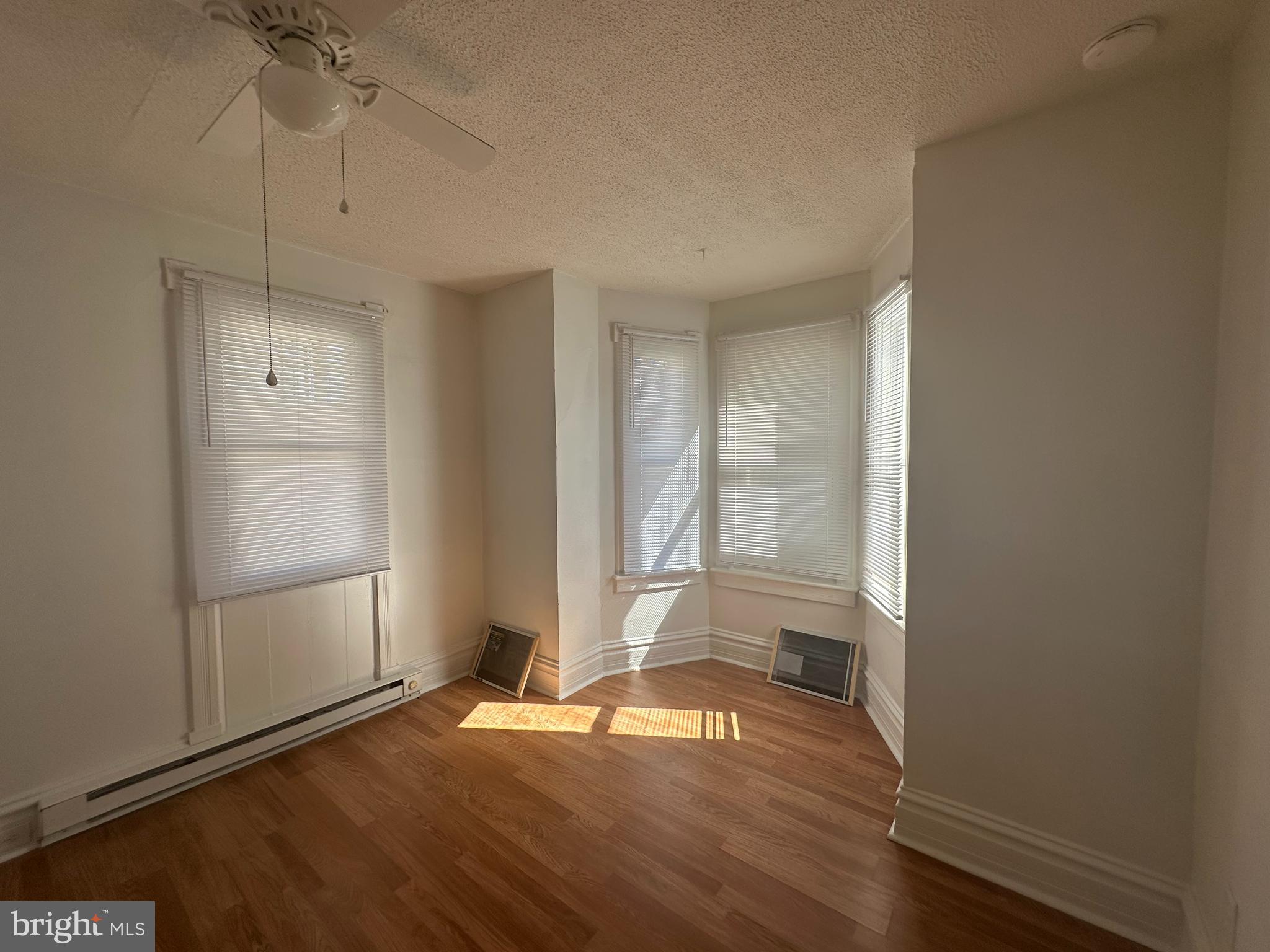 829 Concord Street, Unit A Hagerstown, MD 21740 - Photo 16 of 29 an empty room with wooden floor cabinet and windows