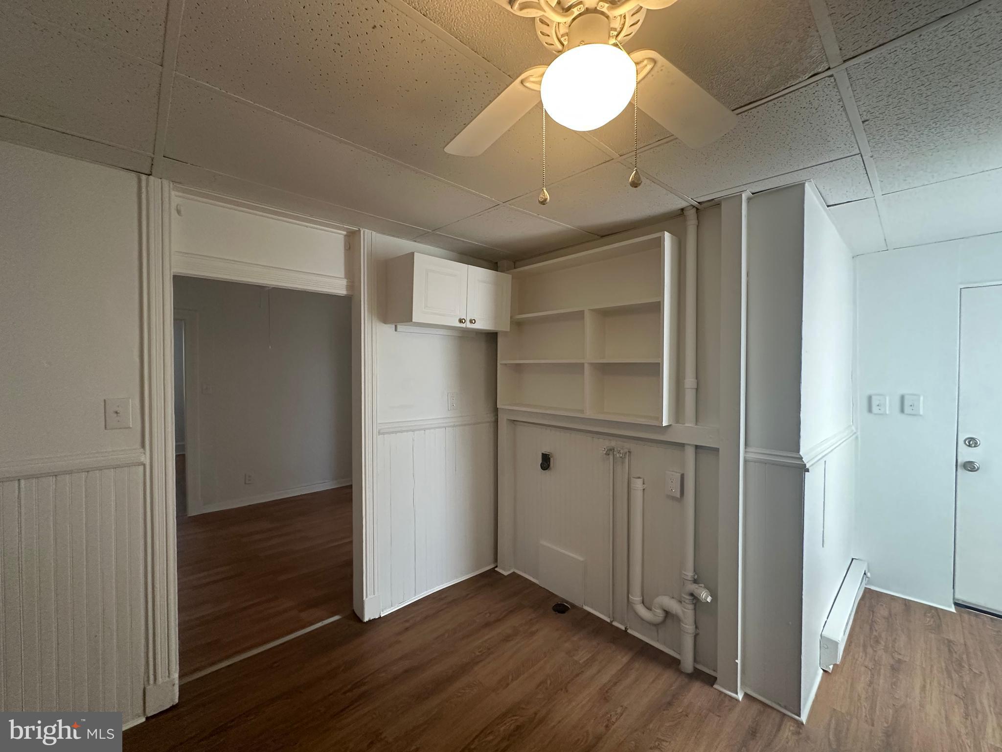 829 Concord Street, Unit A Hagerstown, MD 21740 - Photo 25 of 29 an empty room with wooden floor cabinet and windows