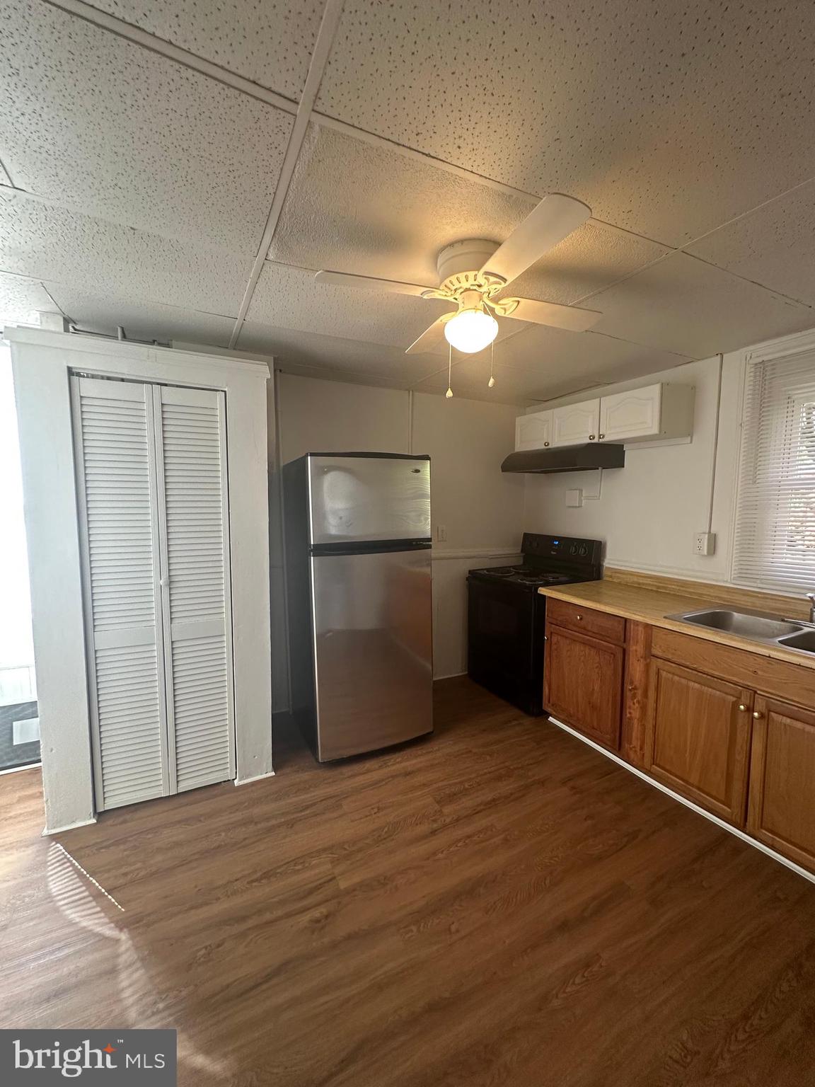 829 Concord Street, Unit A Hagerstown, MD 21740 - Photo 26 of 29 a kitchen with stainless steel appliances granite countertop a refrigerator a sink dishwasher a stove and white countertops with wooden floor