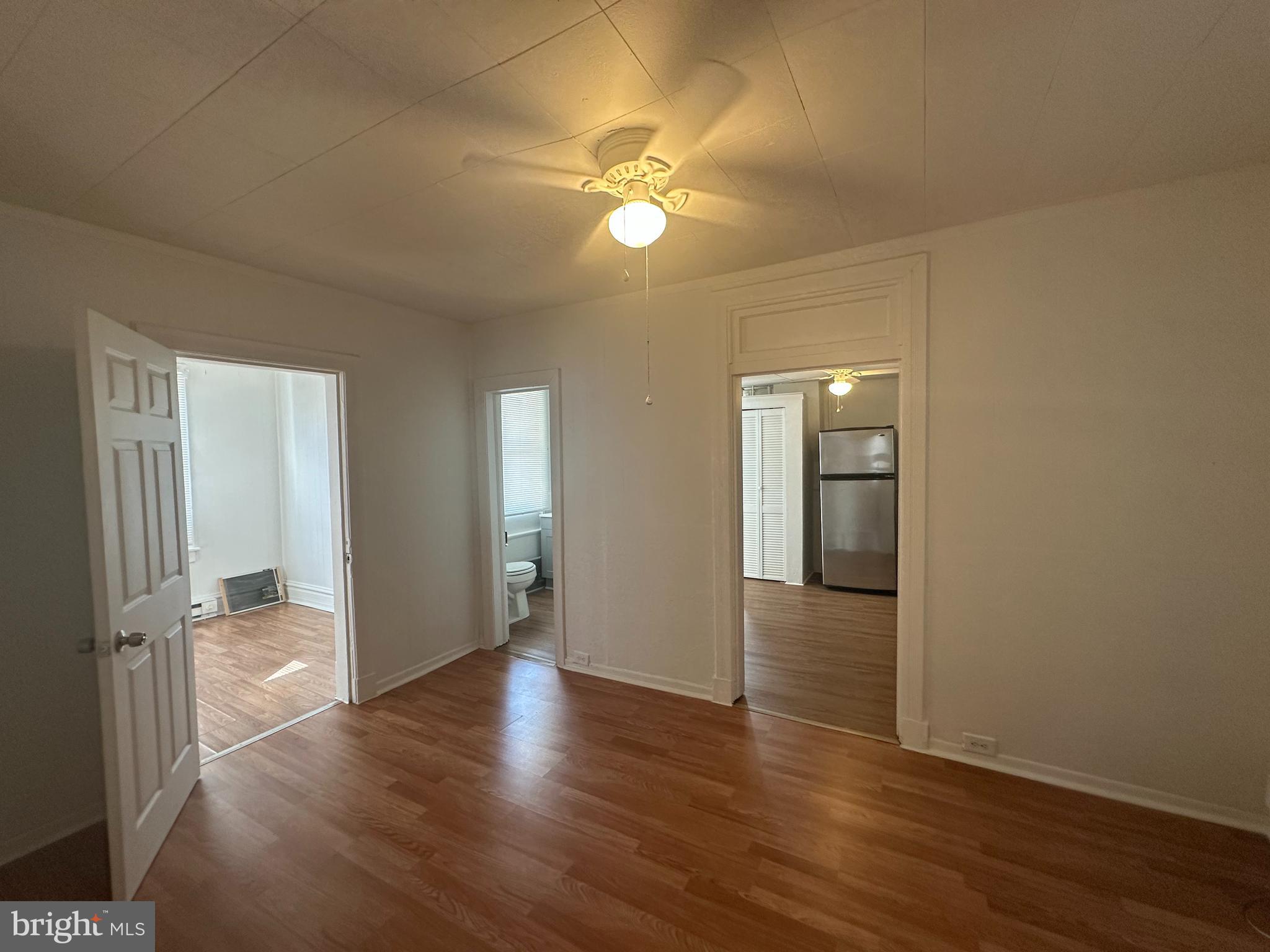 829 Concord Street, Unit A Hagerstown, MD 21740 - Photo 7 of 29 a view of an empty room with wooden floor and a ceiling fan