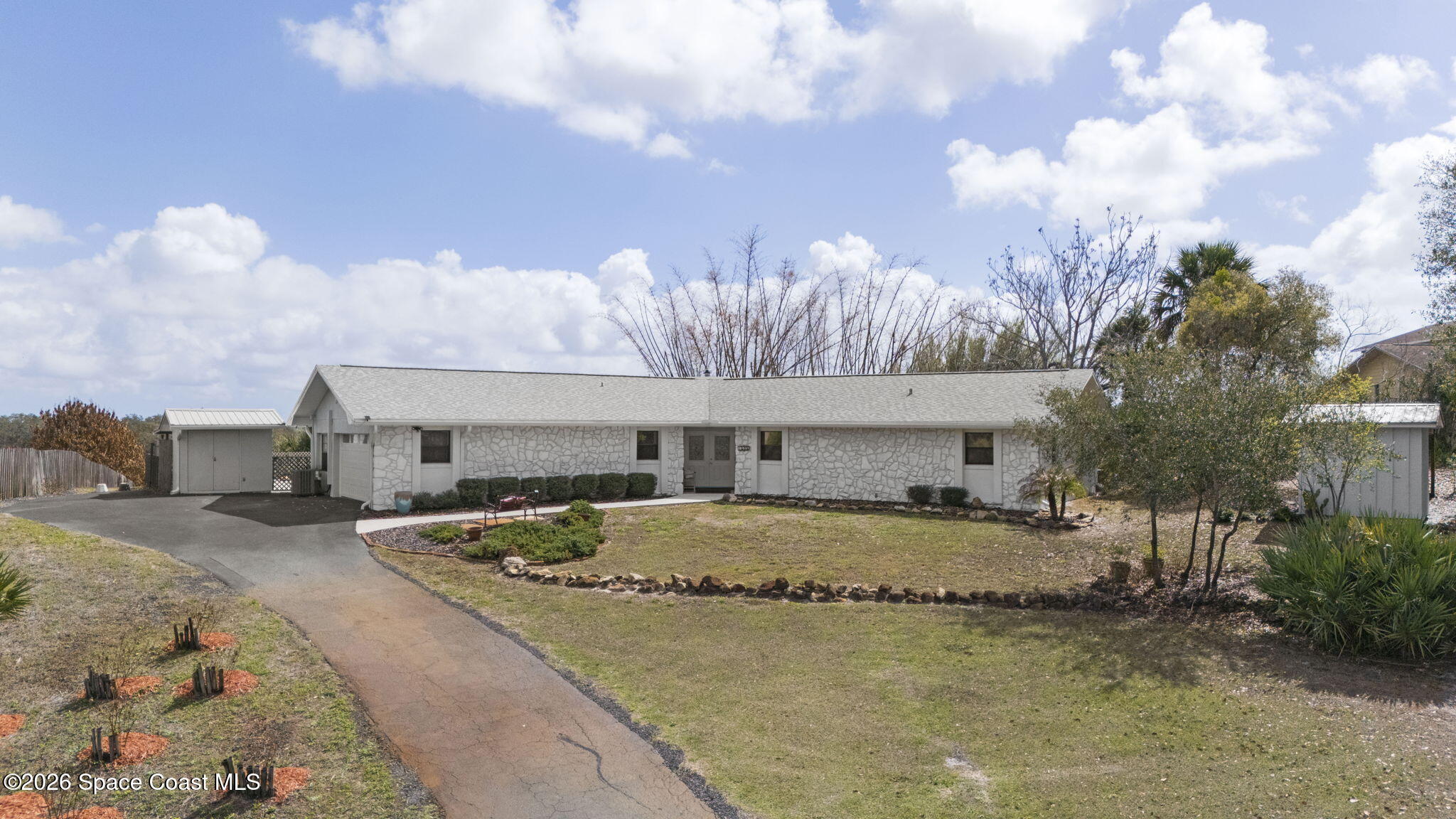 1505 South Carpenter Road Titusville, FL 32796 - Photo 1 of 36 a front view of a house with a yard and garage