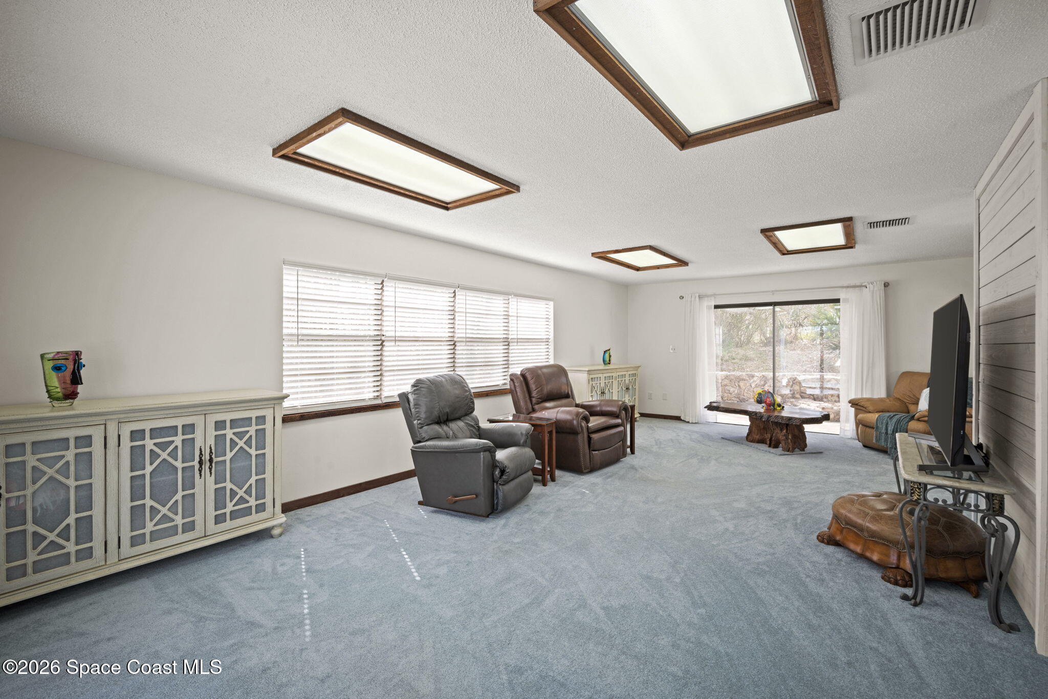 1505 South Carpenter Road Titusville, FL 32796 - Photo 13 of 36 a living room with furniture fireplace and a window