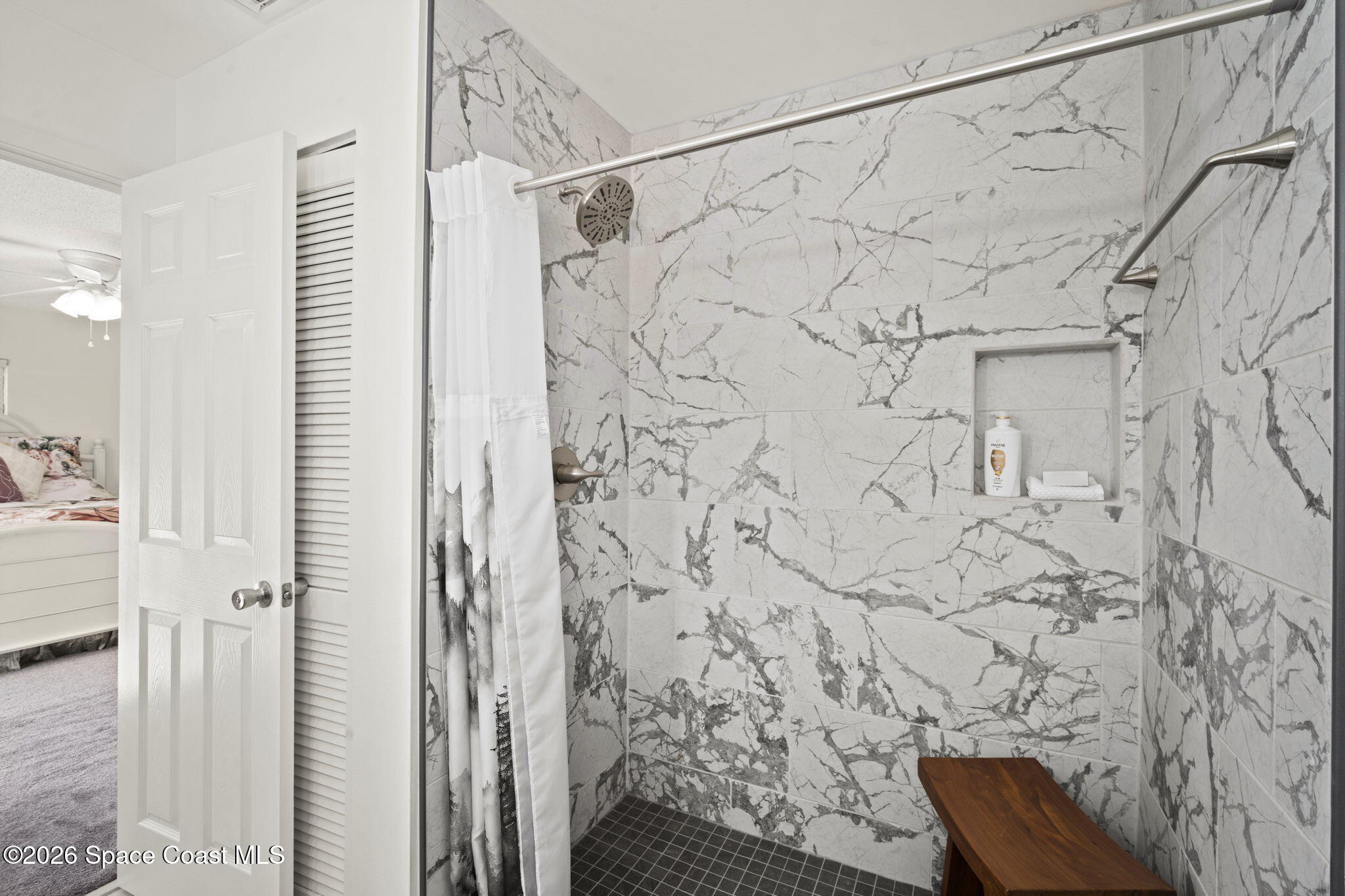 1505 South Carpenter Road Titusville, FL 32796 - Photo 17 of 36 a bathroom with a shower and a shower curtain