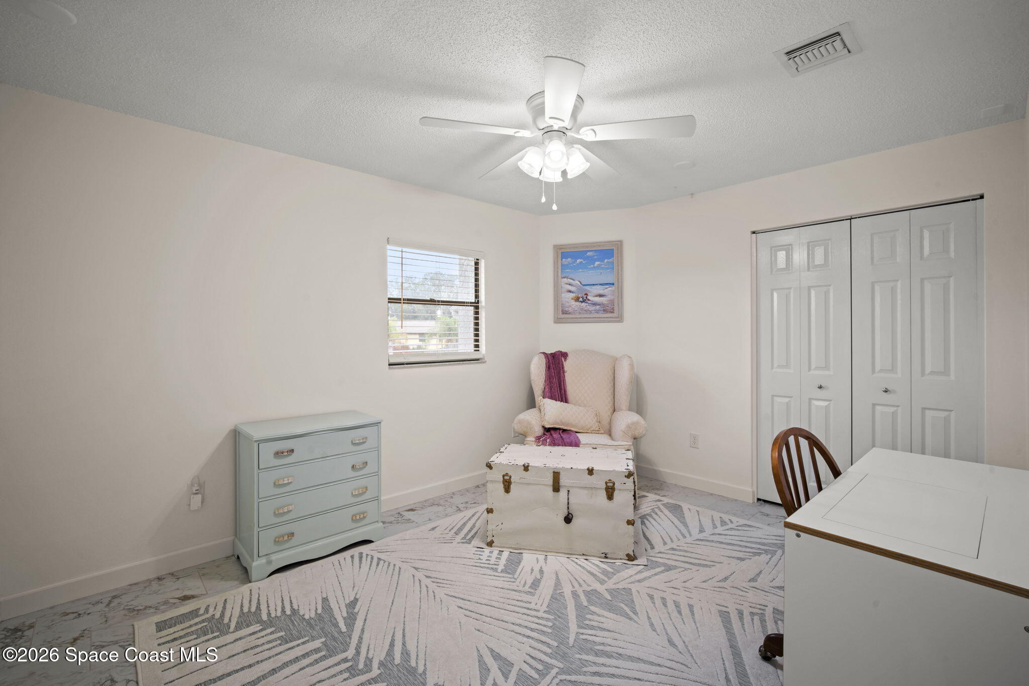 1505 South Carpenter Road Titusville, FL 32796 - Photo 19 of 36 a bedroom with a bed and a chandelier