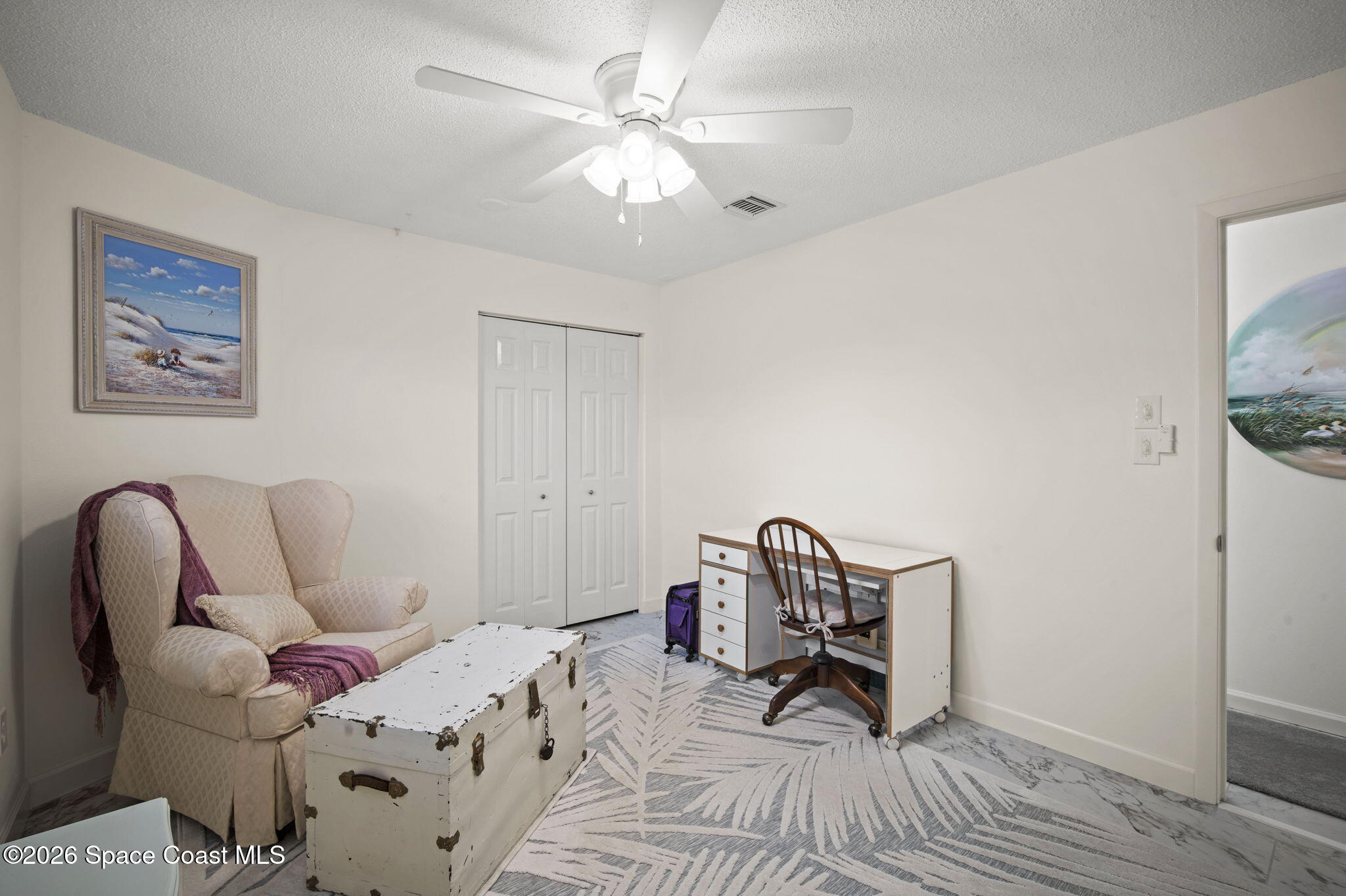 1505 South Carpenter Road Titusville, FL 32796 - Photo 20 of 36 a bedroom with a bed and a chair