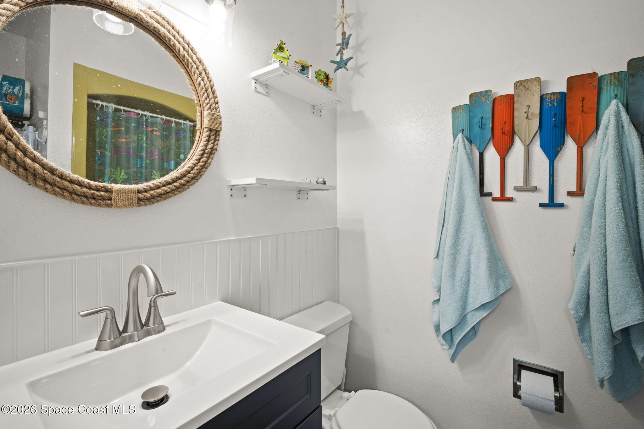 1505 South Carpenter Road Titusville, FL 32796 - Photo 25 of 36 a bathroom with a sink a mirror and toilet