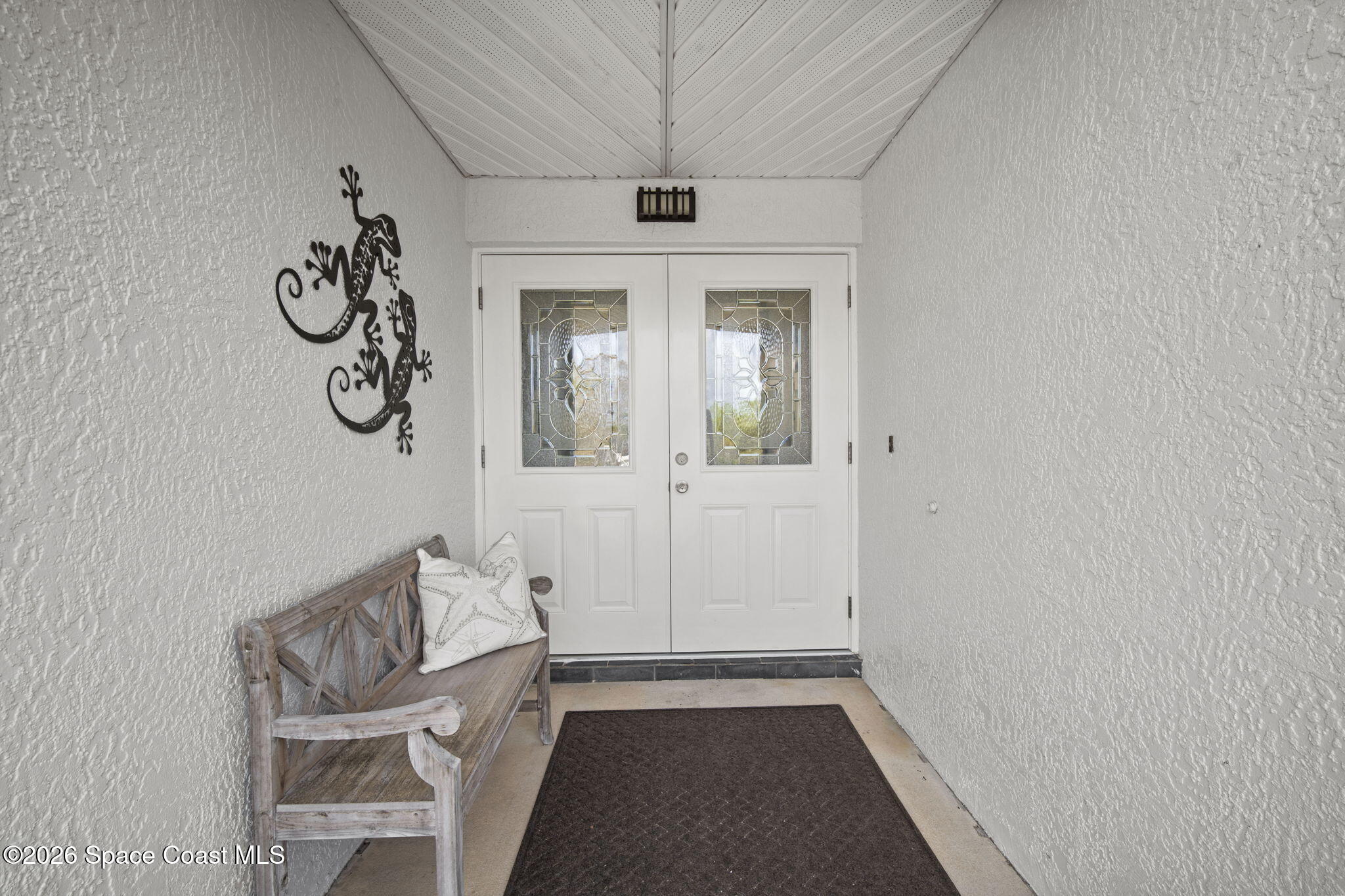 1505 South Carpenter Road Titusville, FL 32796 - Photo 3 of 36 a view of an entryway with table and chair