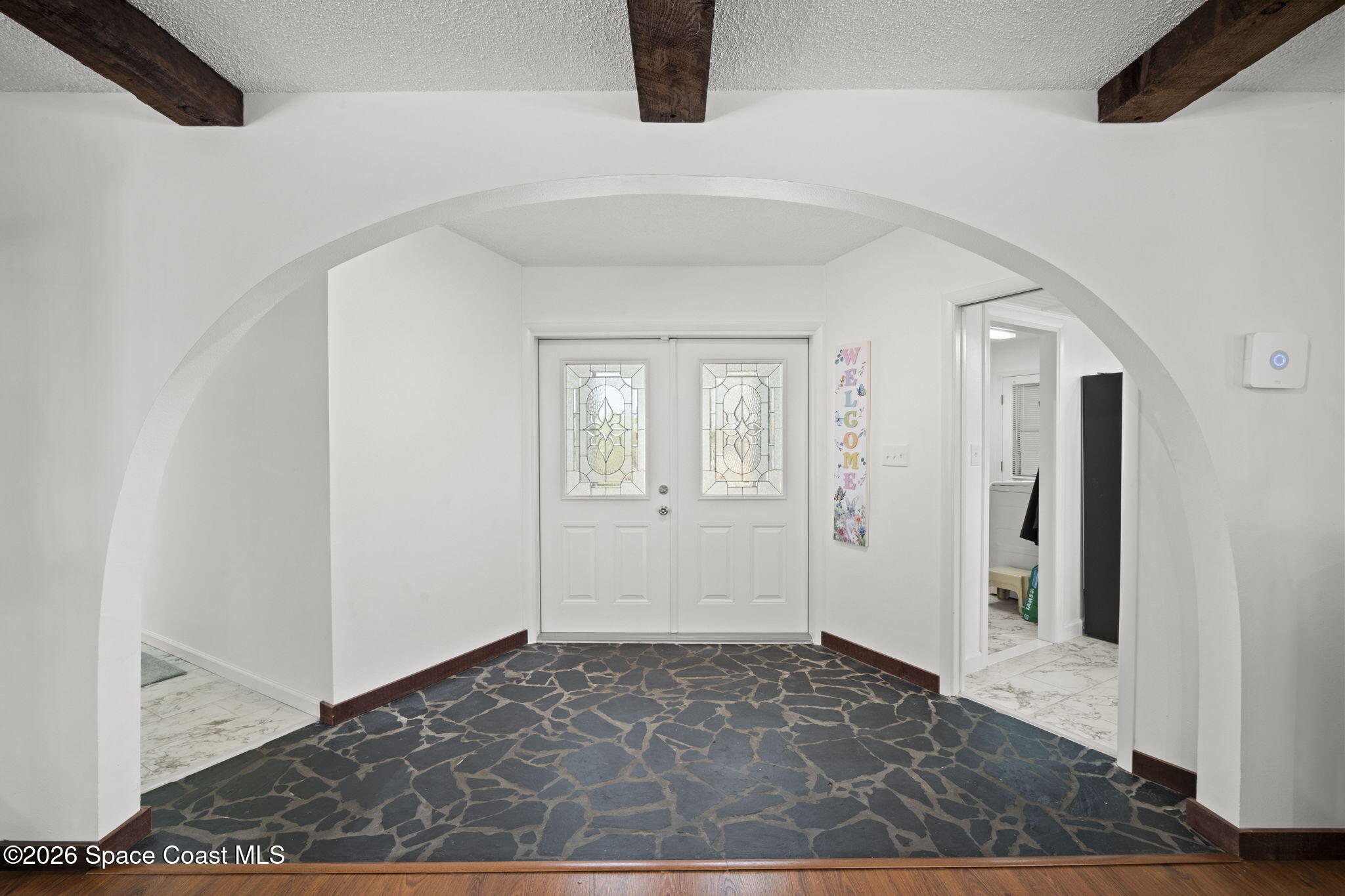 1505 South Carpenter Road Titusville, FL 32796 - Photo 4 of 36 a view of a hallway with wooden floor and entryway