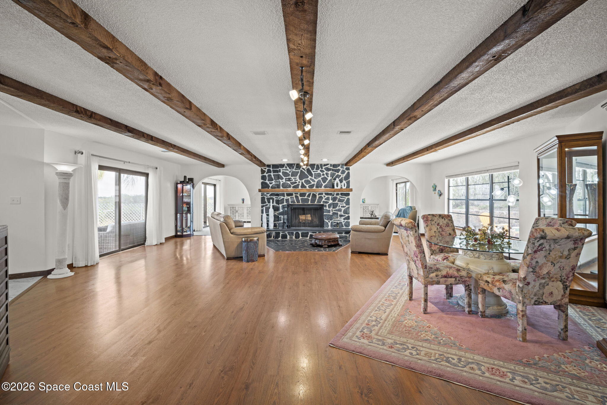 1505 South Carpenter Road Titusville, FL 32796 - Photo 7 of 36 a living room with fireplace furniture and a chandelier