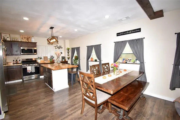 a kitchen with stainless steel appliances granite countertop a sink stove and microwave