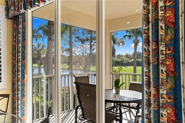 a view of a dining room with furniture water view and backyard