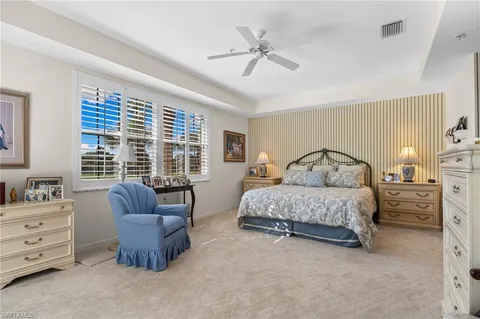 a large bedroom with a large bed and a large window