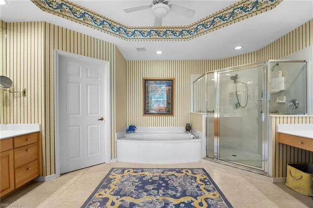 a spacious bathroom with a tub sink shower and mirror