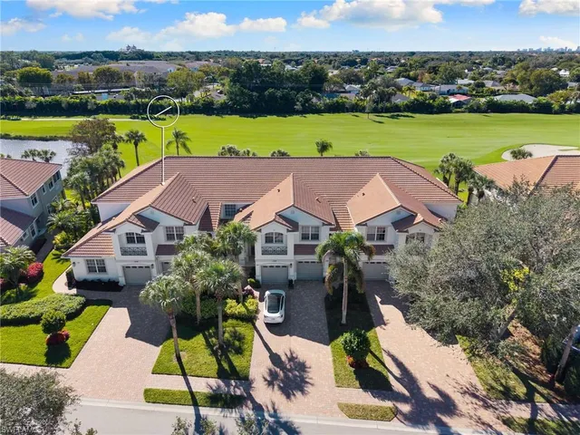 an aerial view of a house with a garden and lake view