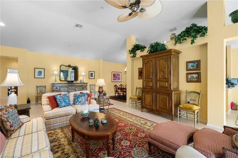 a living room with furniture a rug and a chandelier