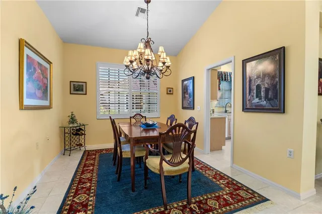 a kitchen with a sink a stove and white cabinets