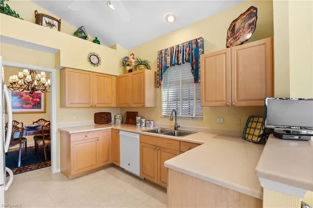 a kitchen with a sink window and cabinets
