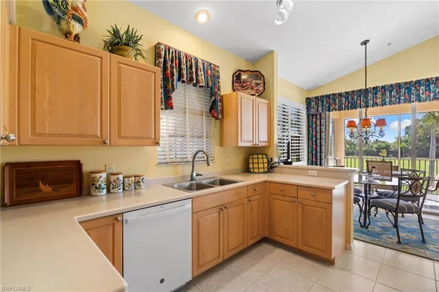 a kitchen with a refrigerator a stove top oven a sink and cabinets