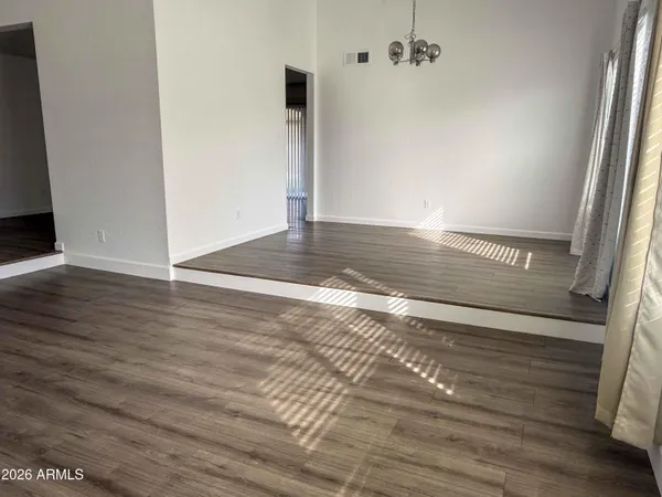 a view of a room with wooden floor
