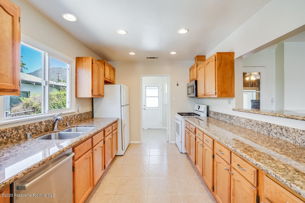 10340 Whitegate Avenue Sunland, CA 91040 - Photo 12 of 27 a large kitchen with stainless steel appliances granite countertop a sink and a stove