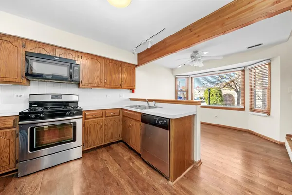 a kitchen with stainless steel appliances granite countertop a stove and a sink