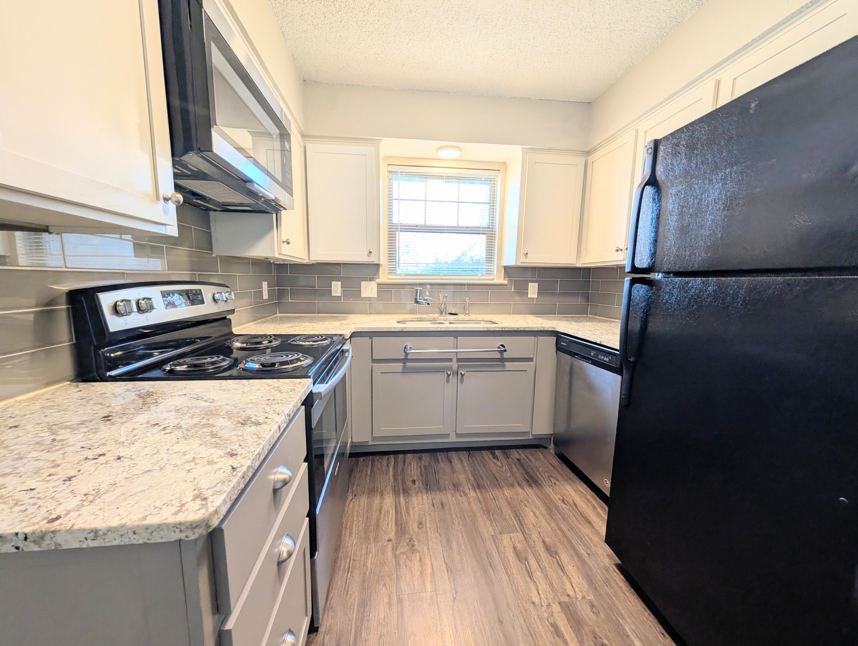 5201 18th Street, Unit A Lubbock, TX 79416 - Photo 2 of 10 a kitchen with a sink stove and refrigerator
