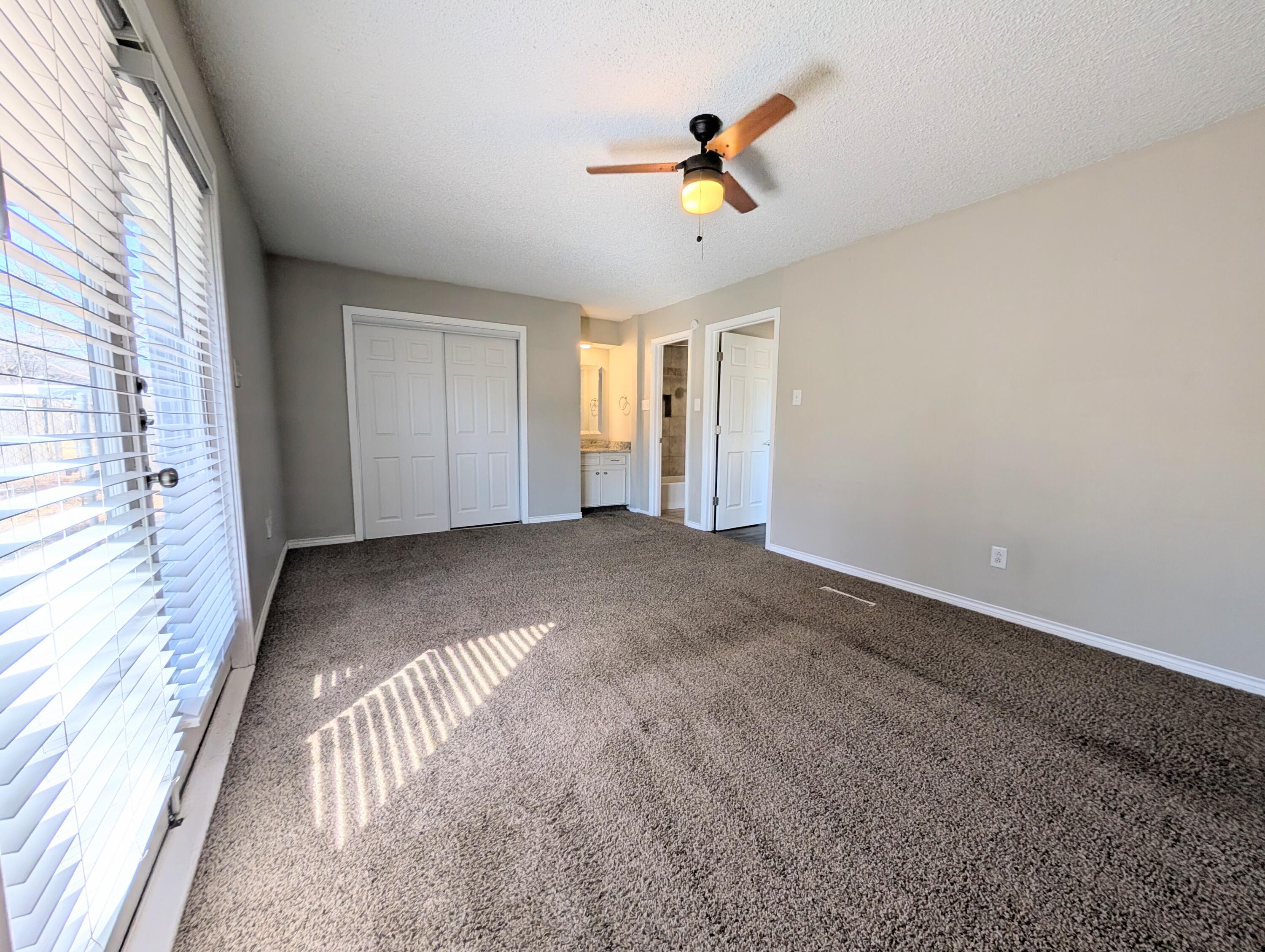 5201 18th Street, Unit A Lubbock, TX 79416 - Photo 6 of 10 a view of empty room with wooden floor and fan