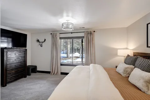 a bedroom with a bed and a television