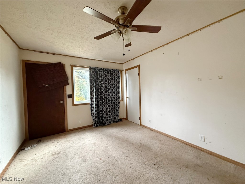 4589 Harmon Creek Road Colliers, WV 26035 - Photo 18 of 26 Unfurnished bedroom featuring a textured ceiling, carpet floors, and a ceiling fan