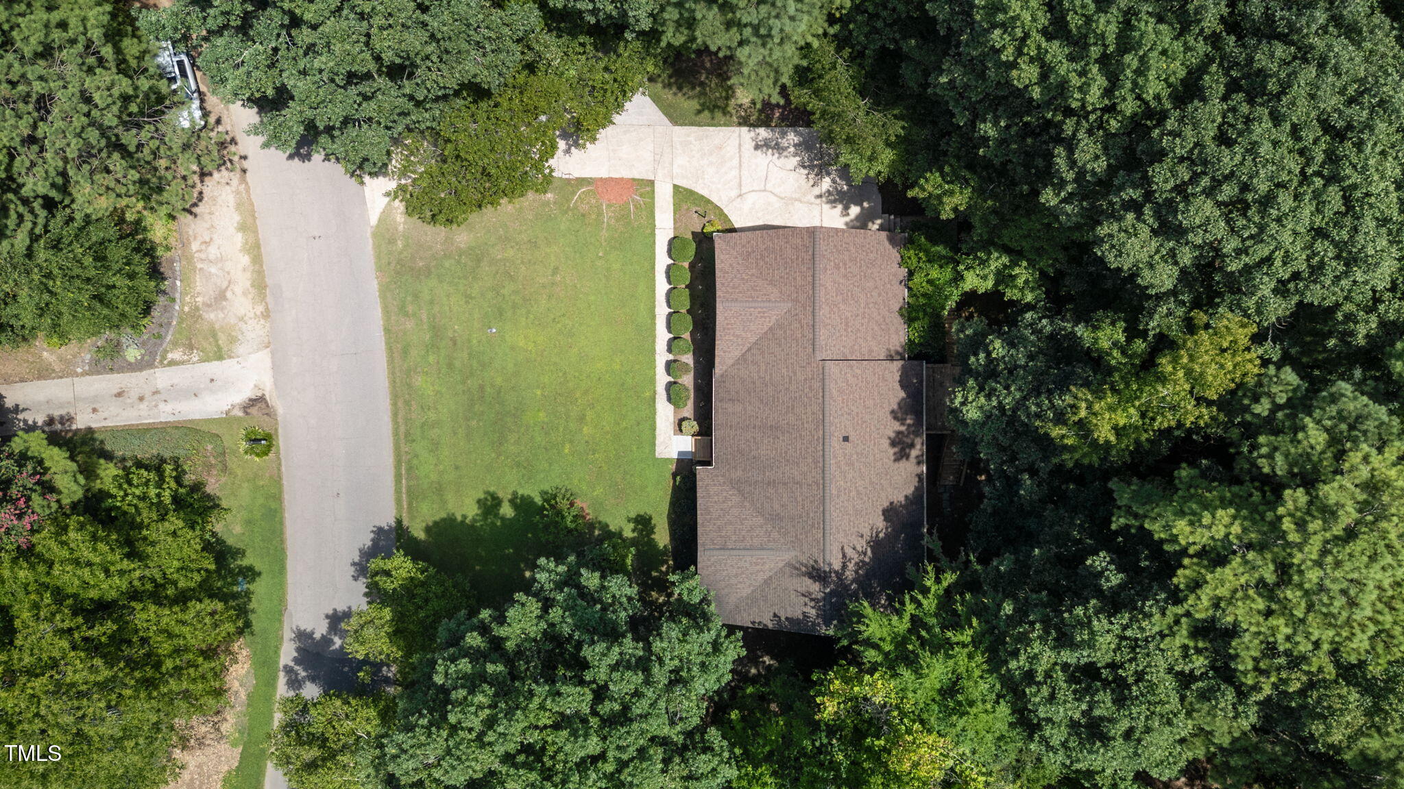 4319 Sprague Road Raleigh, NC 27613 - Photo 6 of 45 an aerial view of a house with a yard and large trees