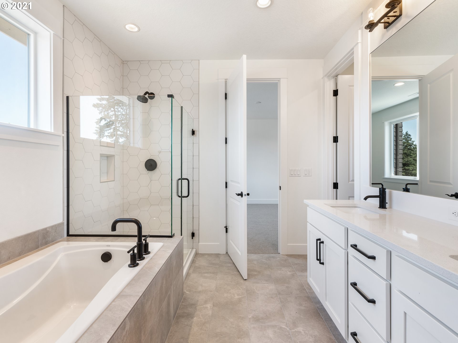 11542 Northwest Kearney Street Portland, OR 97229 - Photo 17 of 24 a spacious bathroom with a tub sink shower and mirror