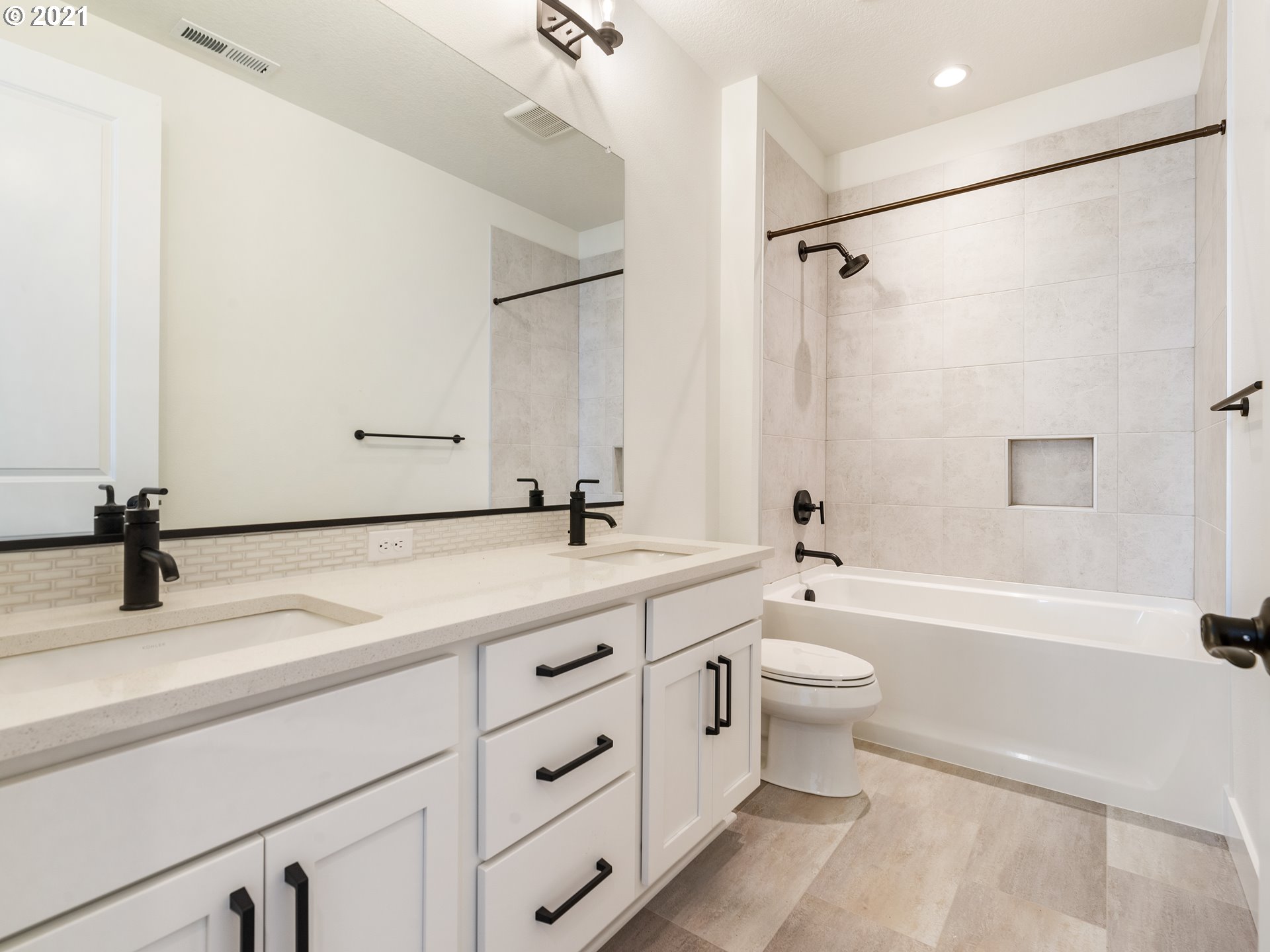 11542 Northwest Kearney Street Portland, OR 97229 - Photo 20 of 24 a bathroom with a double vanity sink toilet mirror and shower