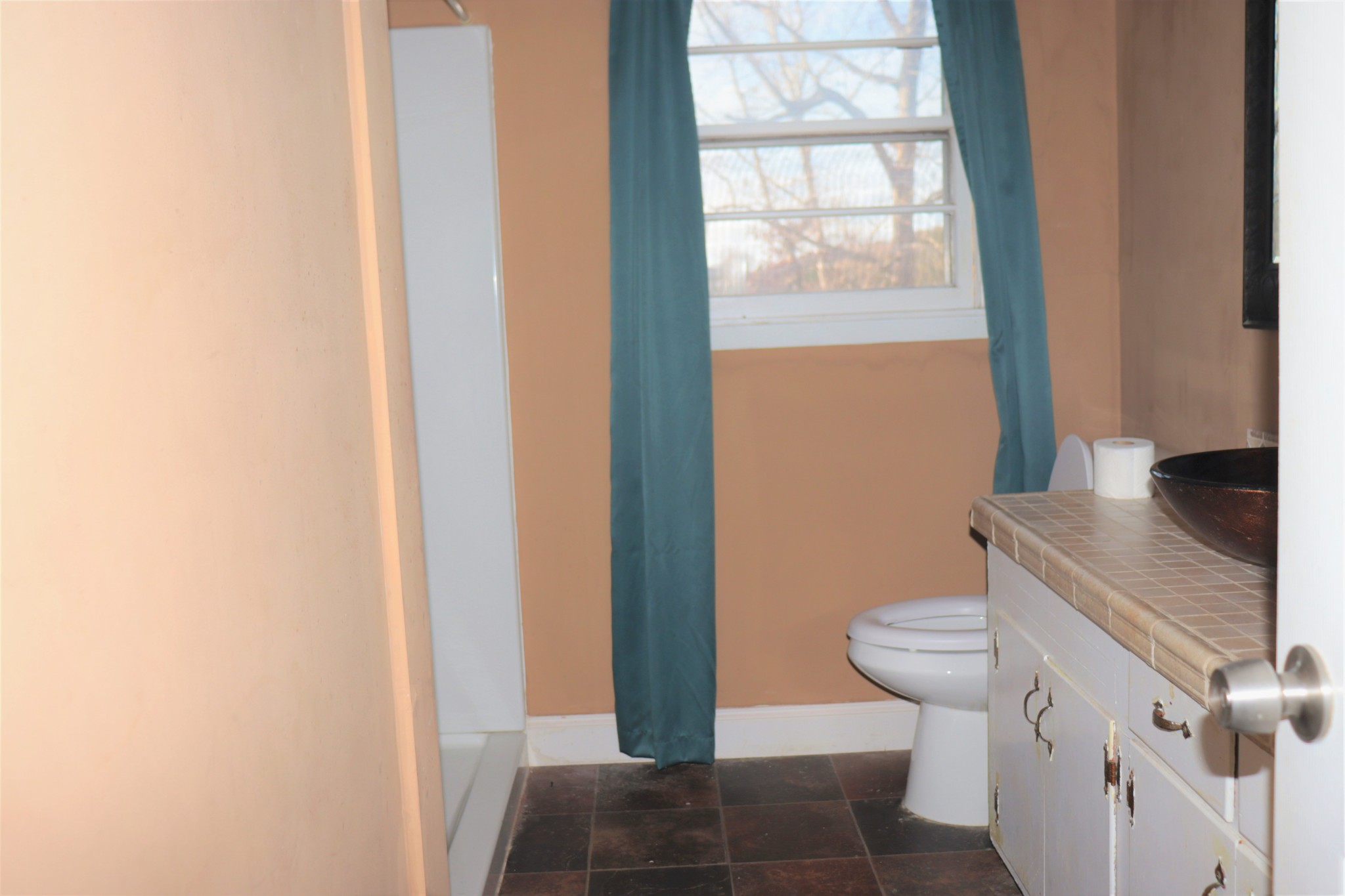 176 Pine Street Parsons, TN 38363 - Photo 13 of 32 a bathroom with a granite countertop sink and a toilet