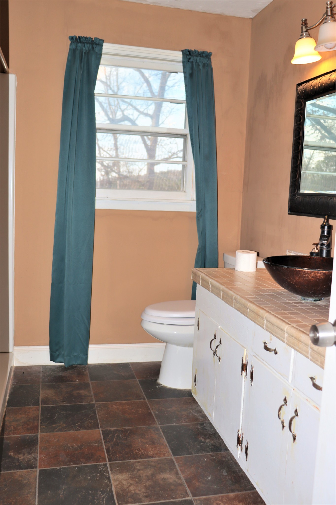 176 Pine Street Parsons, TN 38363 - Photo 15 of 32 a bathroom with a toilet a sink and a mirror